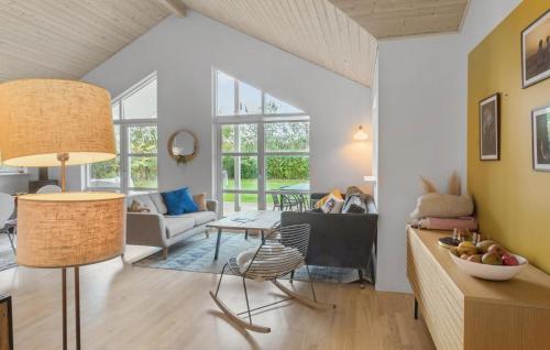 a living room with a couch and a table at Lovely Home In Dannemare With Sauna in Dannemare