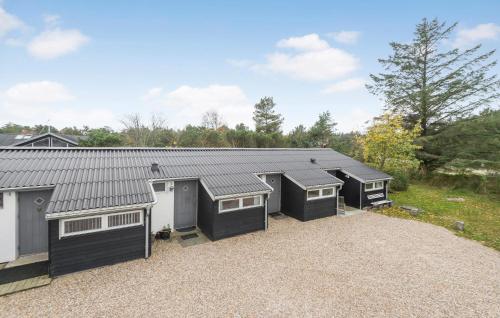 a row of garages in a parking lot at Stunning Apartment In Vejers Strand in Vejers Strand