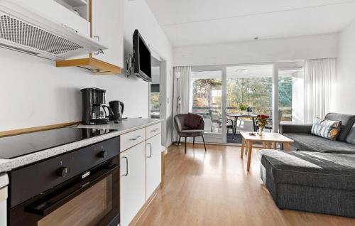 a kitchen and living room with a couch and a table at Nice Apartment In Nexø With Wifi in Neksø