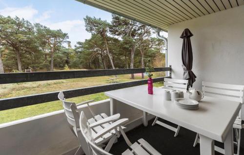 a dining room with a table and chairs and a window at 1 Bedroom Lovely Apartment In Nexø in Neksø