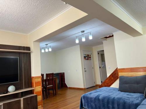 a bedroom with a bed and a flat screen tv at Arriendo Casa dos pisos por dia in Puerto Montt