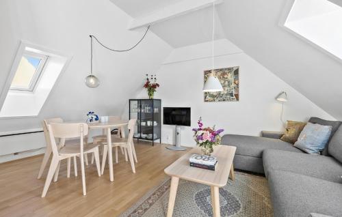 a living room with a couch and a table at Awesome Apartment In Svaneke in Svaneke