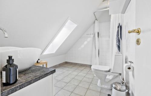 a white bathroom with a sink and a toilet at Awesome Apartment In Svaneke in Svaneke