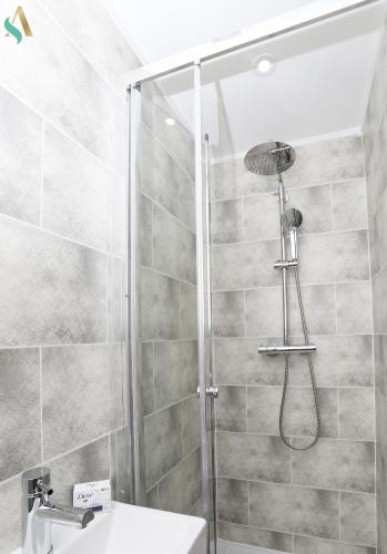 a bathroom with a shower and a sink at Essex Lodge - TSAC in Middlesbrough