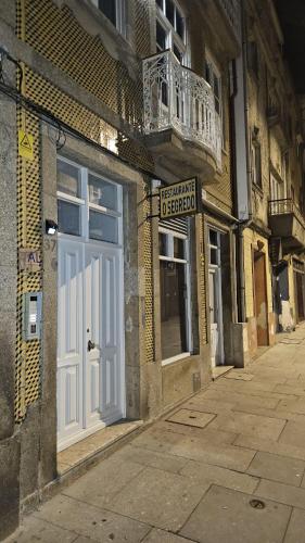 a white door on the side of a building at Rooms4you 1 in historic center of Braga in Braga