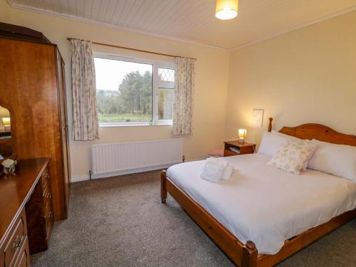 Ένα ή περισσότερα κρεβάτια σε δωμάτιο στο Betty's Farm Cottage