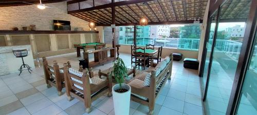 a restaurant with tables and chairs in a room at Pousada Mariá in Cabo Frio