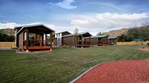 a group of houses with a large yard at The Escape Tiny Home #2 in Orderville