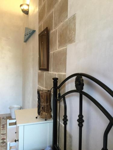 a room with a bed and a table and a wall at U' Iazzu in Avola