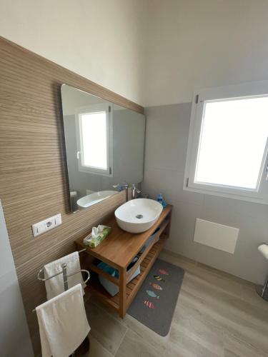a bathroom with a sink and a mirror at Calasetta casa al mare in Calasetta