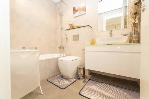 a bathroom with a sink and a toilet and a bath tub at Elegant Studio in Damac Hills - Exclusive Living with Premium Amenities, Managed by Think Realty in Dubai