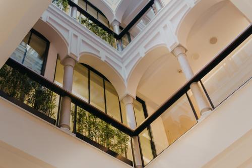 an image of a building with windows at Aquitania Home Suites in Seville