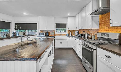 a kitchen with white cabinets and a counter top at New-The Mod Poppy Large home 10 minutes from it all in Waco