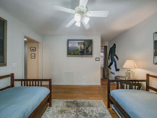 a bedroom with two beds and a ceiling fan at NEW LISTING Sasquatch Lodge F in Gatlinburg