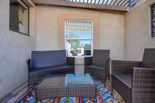 a patio with chairs and a table and a window at Miners Bend - Historic Locale Scenic Workspace in Colorado Springs