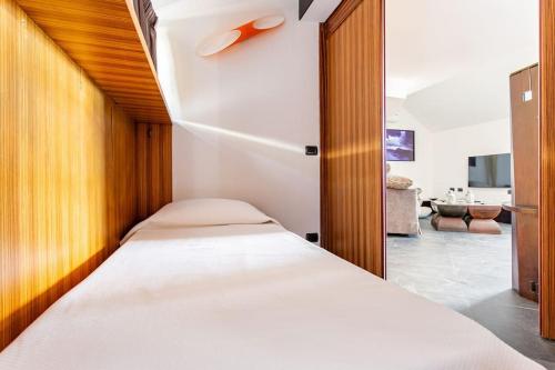 a bedroom with a bed and a living room at Sea View Terrace Sunset-Private Parking in Anacapri