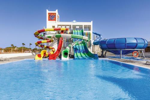 a water park with a water slide in a pool at Hotel Riu Palace Santa Maria - All Inclusive in Santa Maria