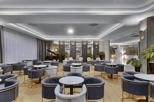 a restaurant with blue chairs and tables at Hotel Riu Palace Santa Maria - All Inclusive in Santa Maria