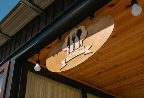 a wooden skateboard hanging from the ceiling of a building at Chateau Ateni Cottages in Gori