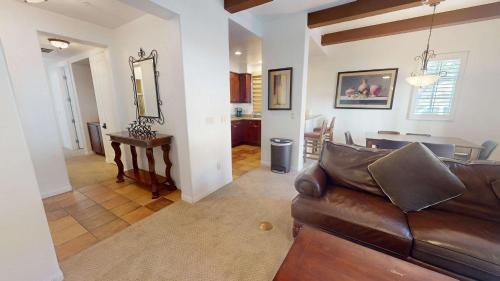 a living room with a leather couch and a dining room at LV214 Convenient Downstairs 2 Bed Legacy Villa in La Quinta