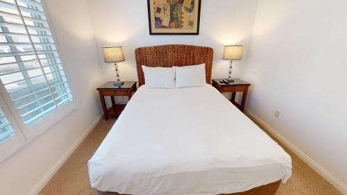a bedroom with a white bed with two night stands at LV214 Convenient Downstairs 2 Bed Legacy Villa in La Quinta