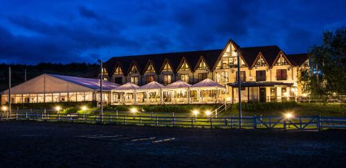 a large building is lit up at night at Conacul Archia in Deva