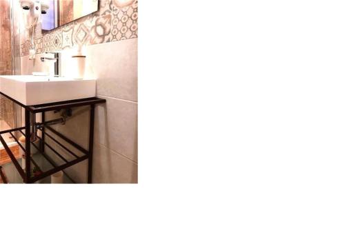 two pictures of a bathroom with a sink at al VECCHIO ARCO Borgo Antico in Bari