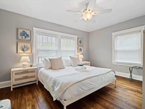 a bedroom with a white bed and a ceiling fan at 19th Century 'Cleveland Double' - Walk To Beach in Cleveland