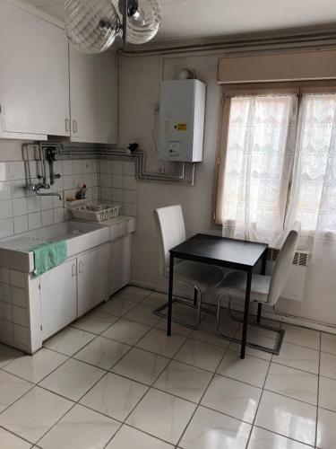 - une cuisine avec une table, une table et des chaises dans l'établissement Maison individuelle, à Colomiers