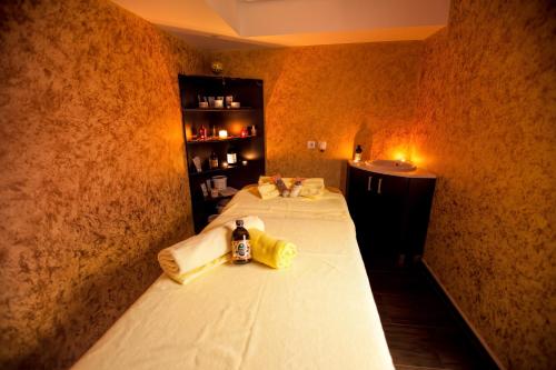 a room with two beds in a room with a shelf at City Palace Hotel in Ohrid