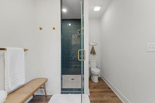 a bathroom with a glass shower with a toilet at Gloria Cottage - 2 blocks to Magnolia and 3 mins to Baylor in Waco
