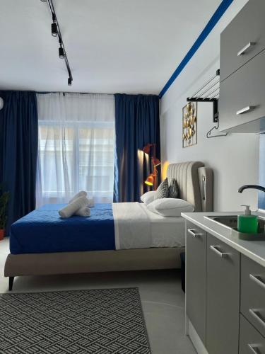 a bedroom with a bed and a window and a sink at Voulis 45 Plaka Suite by Zeussuites in Athens