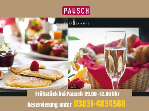 a picture of a plate of food and a glass of wine at Hotel Kontorhaus Stralsund in Stralsund
