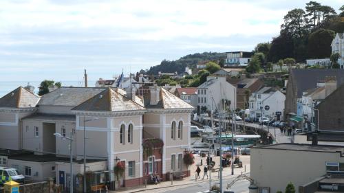 a town with people walking on a city street at Peterborough House in Saint Aubin
