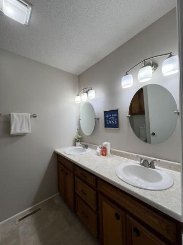 a bathroom with two sinks and a mirror at Paradise Point 2BR 2BA in Lake Murray Shores