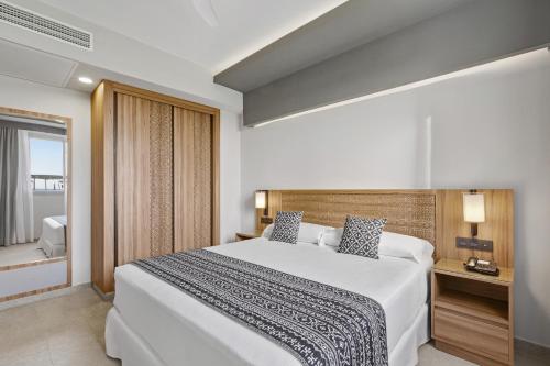 a bedroom with a large white bed and a window at Hotel Riu Palace Santa Maria - All Inclusive in Santa Maria