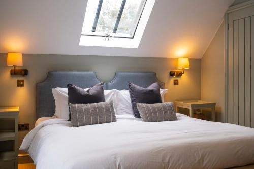 a bedroom with a large white bed with pillows at The Bottle & Glass Inn - Book All 3 Rooms in Henley on Thames