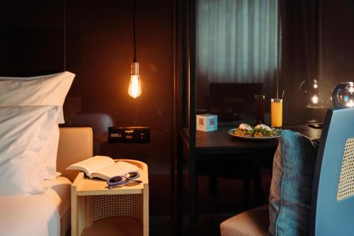 a hotel room with a bed and a table with a plate of food at NEXT - by Savoy Signature in Funchal