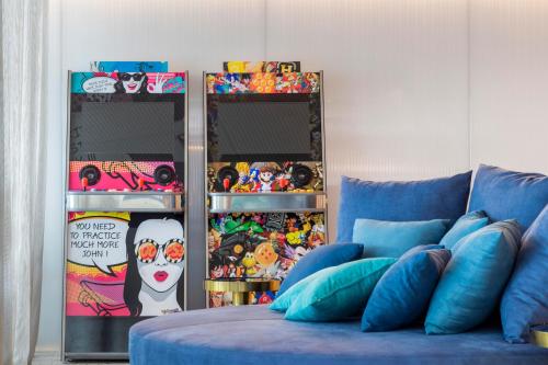 a room with a blue couch and some pictures at NEXT - by Savoy Signature in Funchal