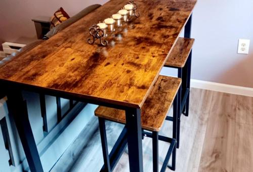 a wooden table with two stools around it at 3-Min Walk Ferry, Free Wi-Fi,Free Spacious Parking in Saint Ignace