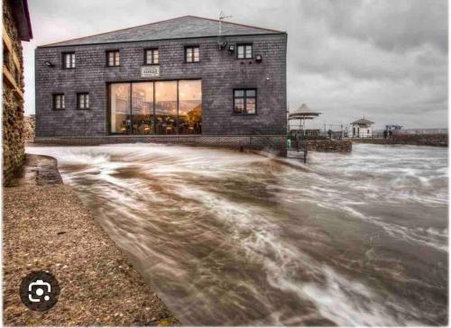 a building in the middle of a body of water at Edwardian house by the seaside in Porthcawl
