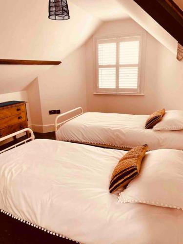 a bedroom with two beds and a window at Edwardian house by the seaside in Porthcawl