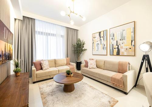a living room with a couch and a table at Stylish Downtown Retreat, Burj Crown, Opera & Boulevard View in Dubai