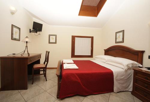 Ένα ή περισσότερα κρεβάτια σε δωμάτιο στο Hotel Ristorante Regina