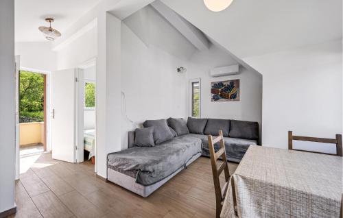 a living room with a couch and a table at Cozy Apartment In Zlarin With Wifi in Zlarin