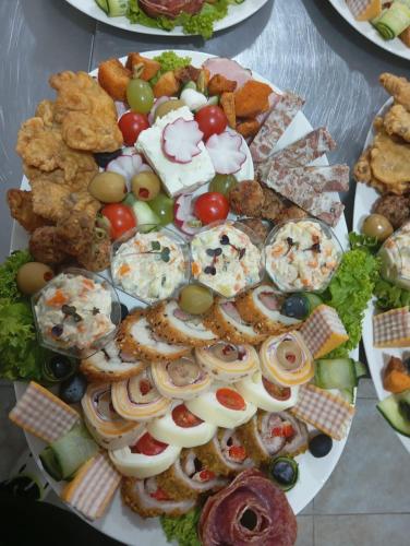 a platter of different types of food on a table at Hotel Măgura Jina in Jina