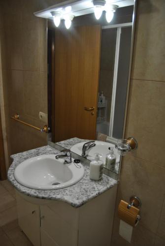 a bathroom with a sink and a large mirror at Casa el Alfar mudéjar in Teruel