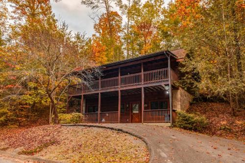 a home in the woods with a driveway at 5 Mins to Pigeon Forge Strip w/ Hot Tub+Grill+MORE in Pigeon Forge