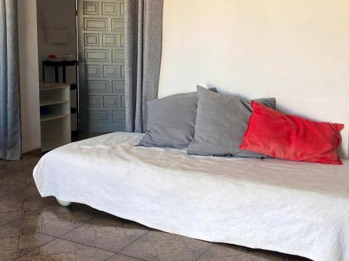 a bed with three pillows on top of it at Centrico Atico Apt Sleeps 4 with Patio in Almuñécar