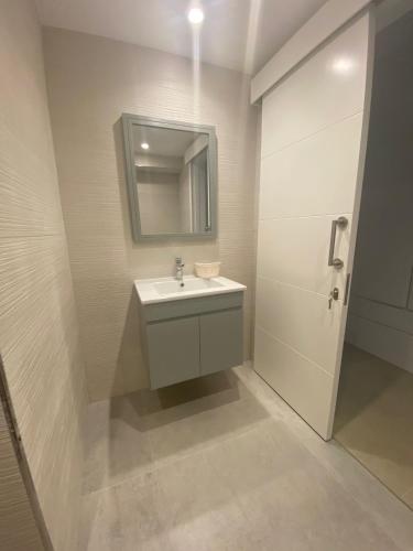 a bathroom with a sink and a mirror and a shower at Blue Serenity - DeJa Blue 2 - C13 in Kalogrea